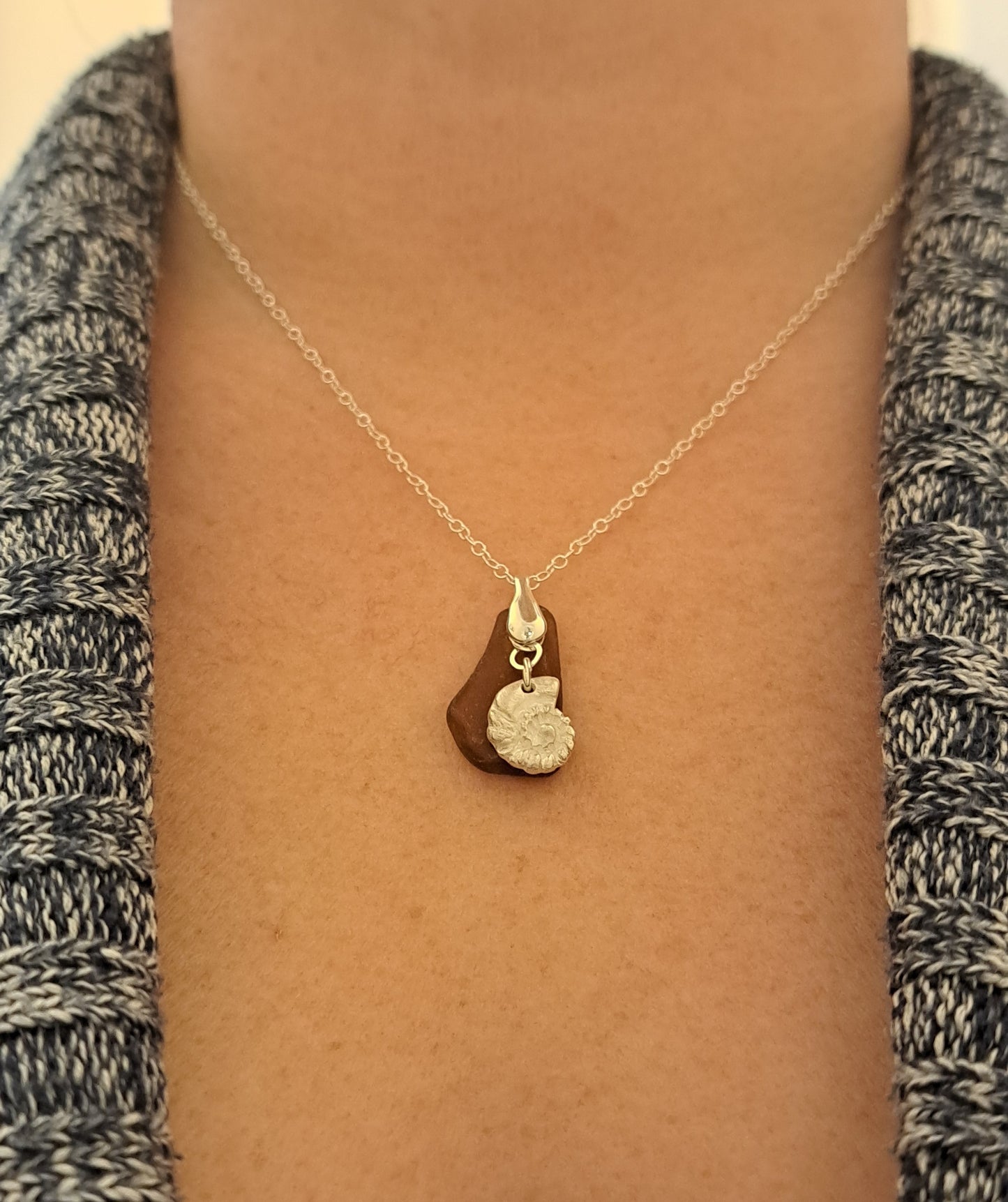 Rich brown sea glass pendant with fine silver ammonite shell