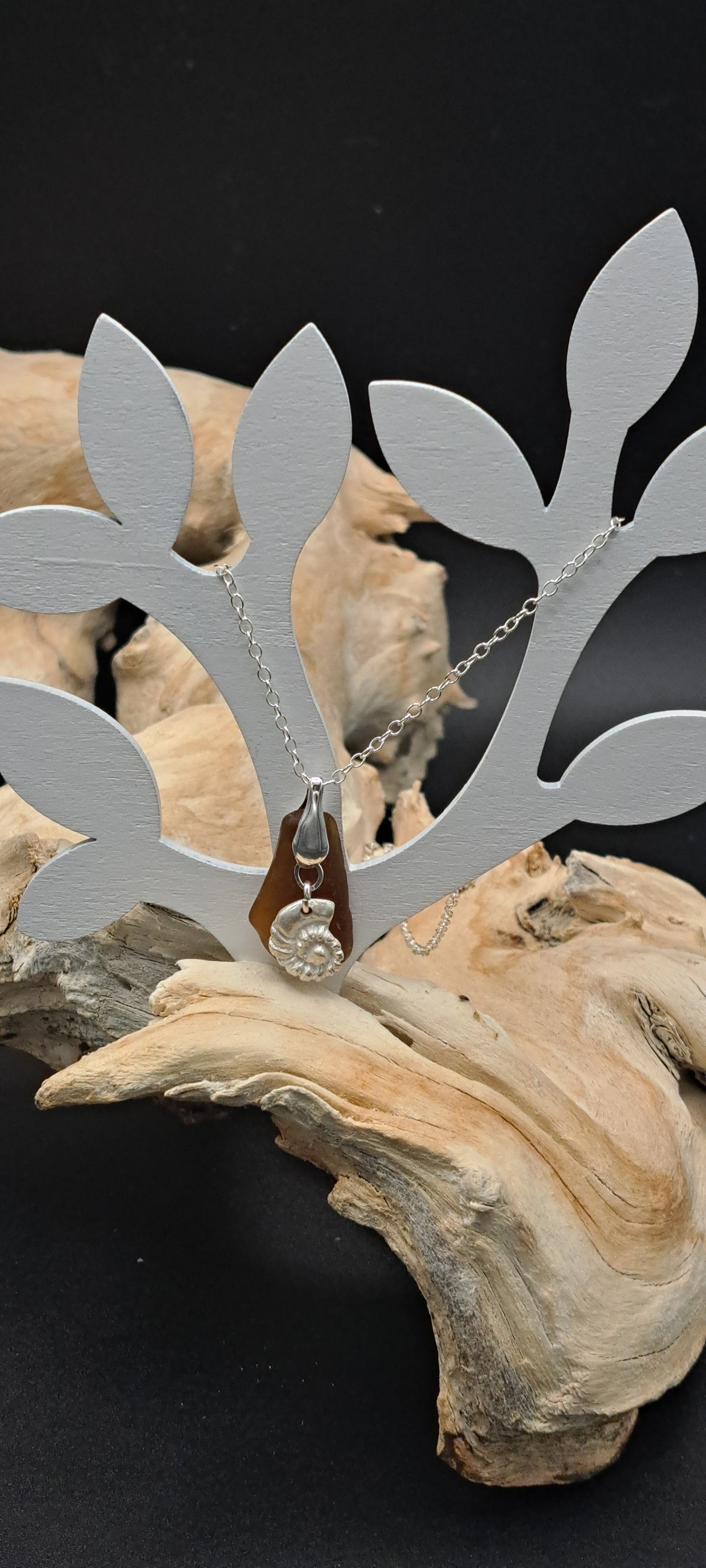 Rich brown sea glass pendant with fine silver ammonite shell