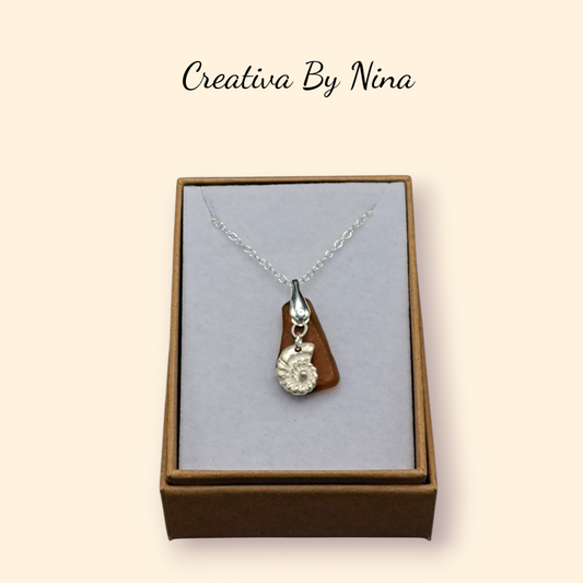 Rich brown sea glass pendant with fine silver ammonite shell